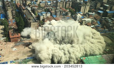 Downtown building demolition by controlled implosion in China