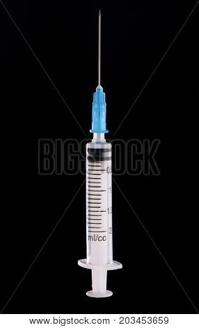 Medical Syringe On A Dark Background
