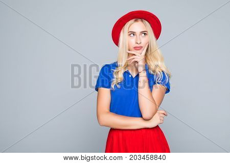 Portrait Of Stylish Smiling Pretty Woman In Red Hat And Spectacles Touching Her Chin With Hand On Gr
