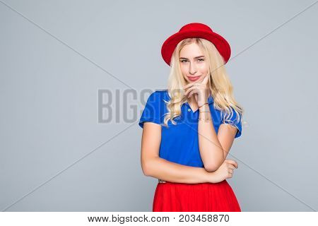 Portrait Of Stylish Smiling Pretty Woman In Red Hat And Spectacles Touching Her Chin With Hand On Gr
