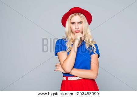 Portrait Of A Stunning Fashionable Lady Offended Girl In Bright Red Dress Posing Over Gray Backgroun