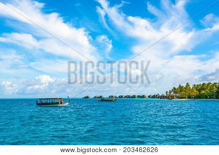 Dhidhoofinolhu Maldives - 5 July 2017: Traditional wooden boat dhoni for tourist excursions in the crystal water of the Indian Ocean Maldives 5 July 2017