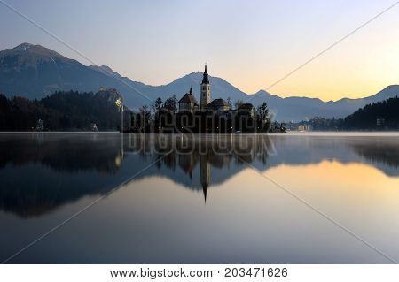 The island of Bled with the Assumption church reflecting on still water.