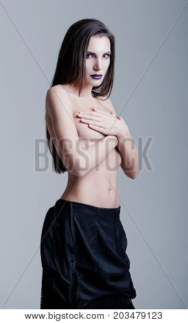 Studio portrait of a beautiful sexy young girl. Topless