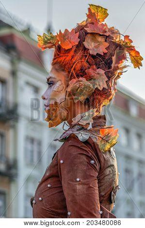 TIMISOARA ROMANIA - SEPTEMBER 8 2017: Living statue of a woman dressed with autumn elements and present on the street inside the CheckART Carnival organized by the City Hall Timisoara. Union Square.