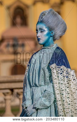 TIMISOARA ROMANIA - SEPTEMBER 8 2017: Living statue of a woman dressed with winter elements and present on the street inside the CheckART Carnival organized by the City Hall Timisoara. Union Square.