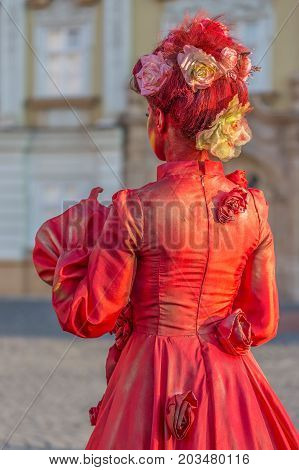 TIMISOARA ROMANIA - SEPTEMBER 8 2017: Living statue of a woman multicolor dressed and present on the street inside the CheckART Carnival organized by the City Hall Timisoara. Union Square.