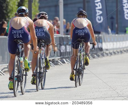 STOCKHOLM - AUG 26 2017: Rear view of leading female trio triathlete cyclists Zaferes Duffy and Learmonth in the Women's ITU World Triathlon series event August 26 2017 in Stockholm Sweden