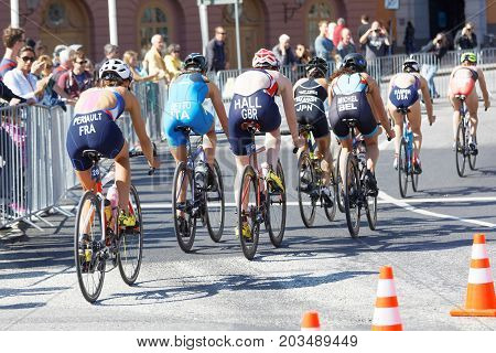 STOCKHOLM - AUG 26 2017: Rear view of a largegroup of female triathlete cyclists in the Women's ITU World Triathlon series event August 26 2017 in Stockholm Sweden