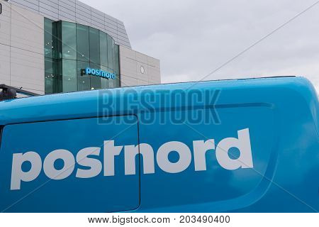 Van and building with the blue logo postnord Amager Copenhagen Denmark September 8 2017