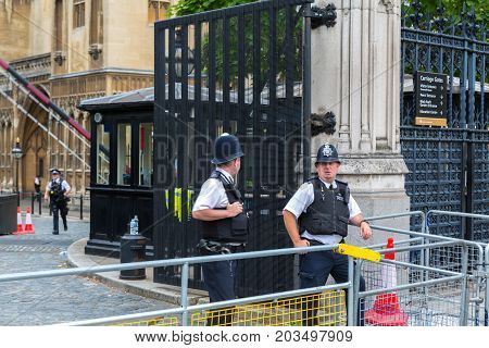 Westminster London - 14th August 2017 - Two armed police officers stand guard outside the Houses of Parliament