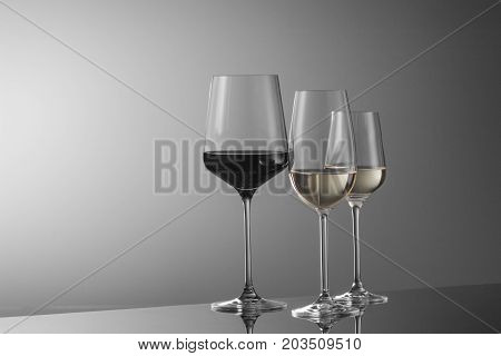 a few glasses of wine on a light background