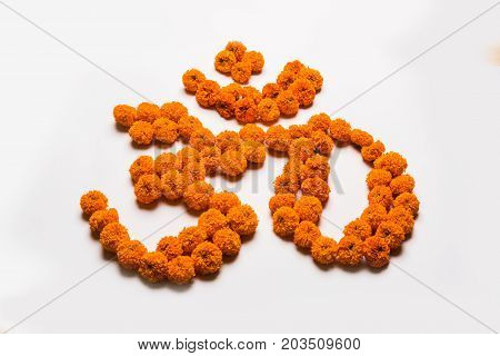 Stock photo of word Aum or om made using marigold flower arrangement