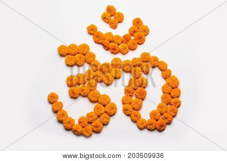 Stock photo of word Aum or om made using marigold flower arrangement