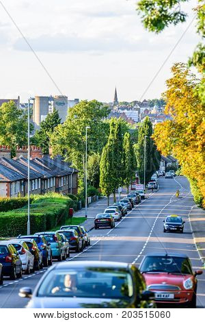 Northampton UK - Aug 15 2017: Cloudy Day Cityscape View of Northampton UK with road in foreground.