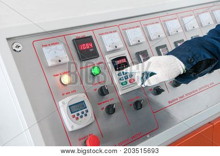 closeup of the working hand on the remote machine control. worker operates the machine from the control center