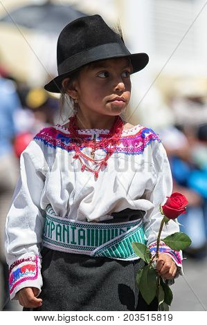 June 17 2017 Pujili Ecuador: young quechua girl in traditional wear holding a flower in the Corpus Christi parade