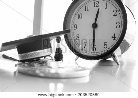 Graduation cap on Golden medals with clock graduate education in university Competitions and Educational study concepts. Success in study famous institution Concept of winner abroad international.