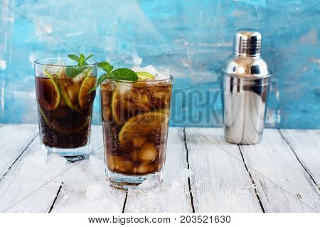 Summer cuba libre cocktail with lime and mint. Space for text