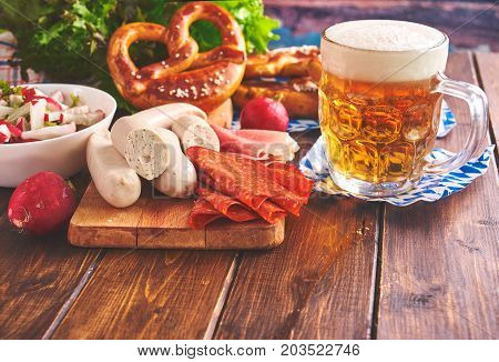 Traditional munich Oktoberfest food including white sausages, pretzels and beer. Toning.