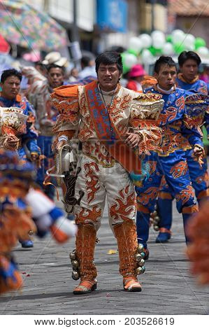 June 17 2017 Pujili Ecuador: indigenous kichwa man in colourful costume dancing on the street during Corpus Christi parade