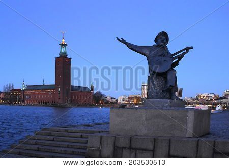 Stockholm Sweden - January 05th 2015: Statue of Evert Taube . View of the Stockholm City Hall.