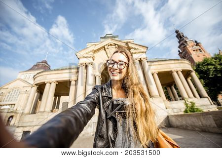 Portrait of a young woman tourist on the Haken terrace traveling in Szczecin city in Poland