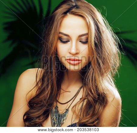 young cute blonde woman on green palm background smiling happy, lifestyle peole concept close up