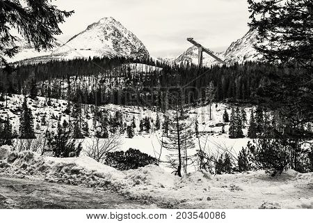 Solisko peak with springboard for ski jumping Strbske pleso Slovak republic. Winter mountains. Black and white photo.