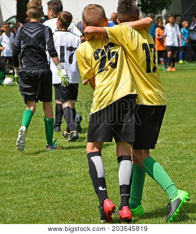 Young soccer players are happy after winning the match