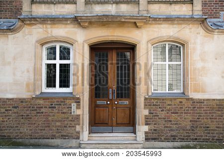 LONDON, UK - 25 August, 2017: Entrance door of old house in Kensington.  Facade of residential buildings in the Kensington, one of the most expensive places to live in UK. Gloucester street.
