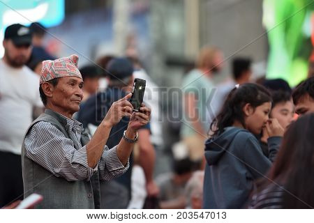 NEW YORK CITY - AUG. 26 : Unidentified people on the Times Square in Manhattan on August 26 2017 in New York City NY. Times Square is a major tourist destination and entertainment center.