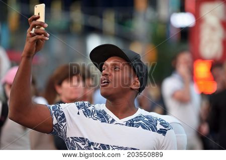 NEW YORK CITY - AUG. 26 : Unidentified people on the Times Square in Manhattan on August 26 2017 in New York City NY. Times Square is a major tourist destination and entertainment center.