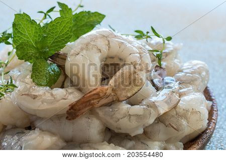 Raw fresh shrimps in  a wooden plate.