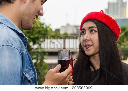 Young people holding glass talk in the party.