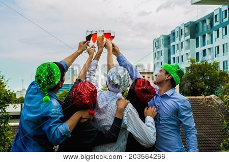 Young people holding glass talk in the party.