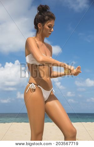 Beach Body Suntan Skin Care Travel Vacation. Bikini Hat Woman Applying Sunscreen Lotion Putting Crea