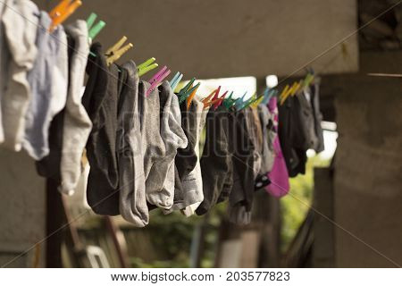 colorful socks hanging on a rope with blurred background