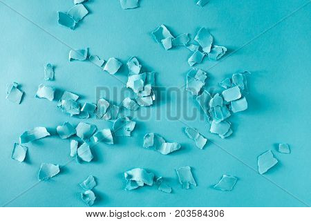 Scattered paper shreds on a blue background