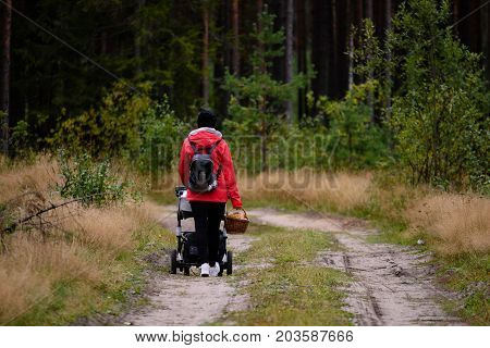 Young Woman In Red Jacket Enjoying Nature In Forest. Latvia