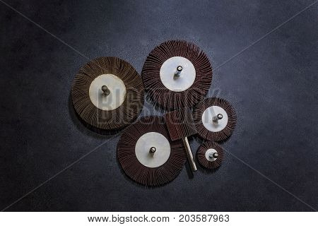Flap Wheel. A pile of color abrasive Flap Wheel industrial on wood background texture. sandpaper for metal working
