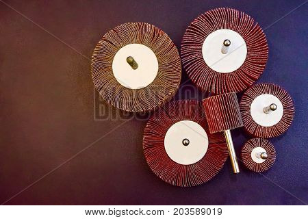 Flap Wheel. A pile of color abrasive Flap Wheel industrial on wood background texture. sandpaper for metal working