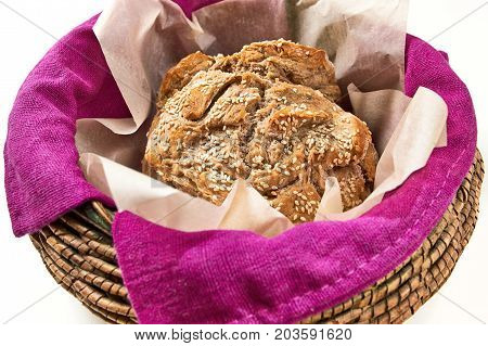 Round Loaf Of Home Made Bread In A Basket, Close Up (isolated On White).