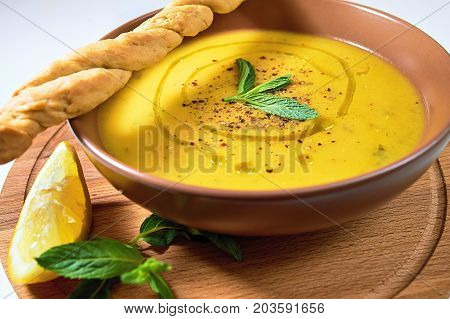 Turkish Traditional Lentil Cream Soup With Mint, Lemon And Homemade Bread. Ezogelin.