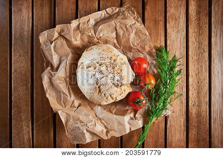 Wholegrain Brioches Made With Coriander Seeds And Tomatoes, Served On Paper And Wooden Tray; Top Vie