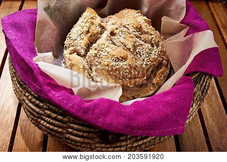 Round Loaf Of Home Made Bread In A Basket, Close Up.