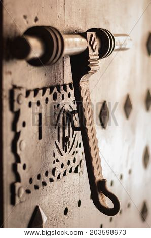 ancient iron door knocker on medieval house