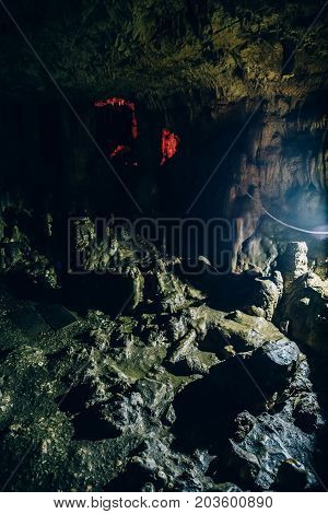 Big dark underground cave, toed, vertical photo