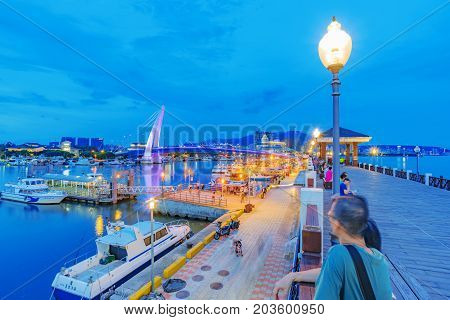TAIPEI TAIWAN - JULY 05: This is an evening view a pier in the fisherman's wharf area of Tamsui where people come to enjoy the scenic views of the area on July 05 2017 in Taipei