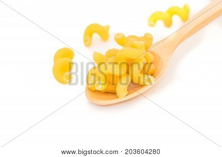 Raw Italian Macaroni Pasta on wooden spoon.